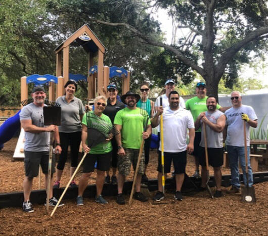 Employees from Humana volunteering to refurbish the family shelter playground