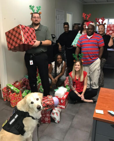 Staff preparing to hand out Christmas gifts from the adopt-a-family drive that I coordinated