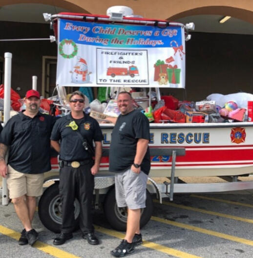 Seminole firefighters at their annual &quot;Fill the Fireboat&quot; toy drive that resulted in a box truck load of toys