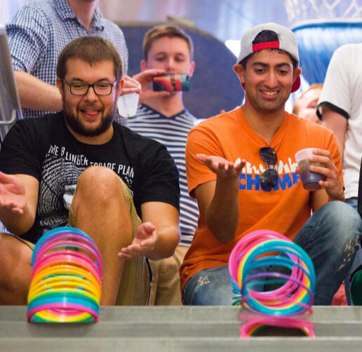Grown Up Night guests having slinky races down the stairs