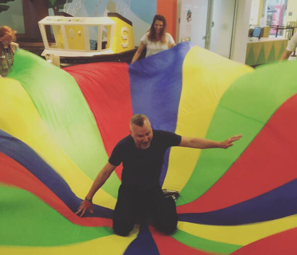Grown Up Night guest enjoying the parachute activity