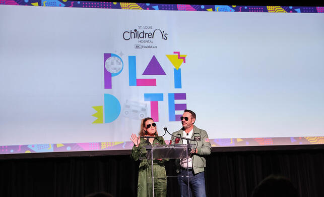 The event chairs dressed up as Top Gun characters to open the program