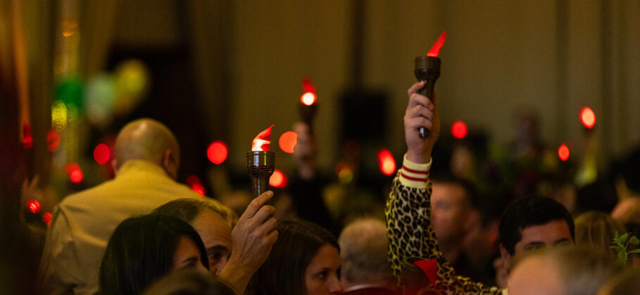 Guests holding light up torches