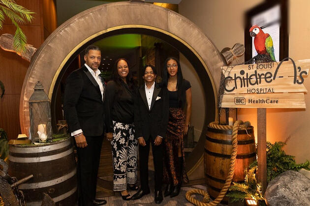 Featured patient family at the entryway of the event