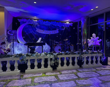 The themed stage for the band at the after-party, including the custom named banner for our sponsor