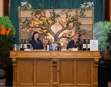 Custom-made backlit tree bar to represent the tree of life that is a common element in stories.